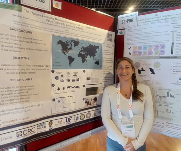 Woman standing in front of scientific poster.